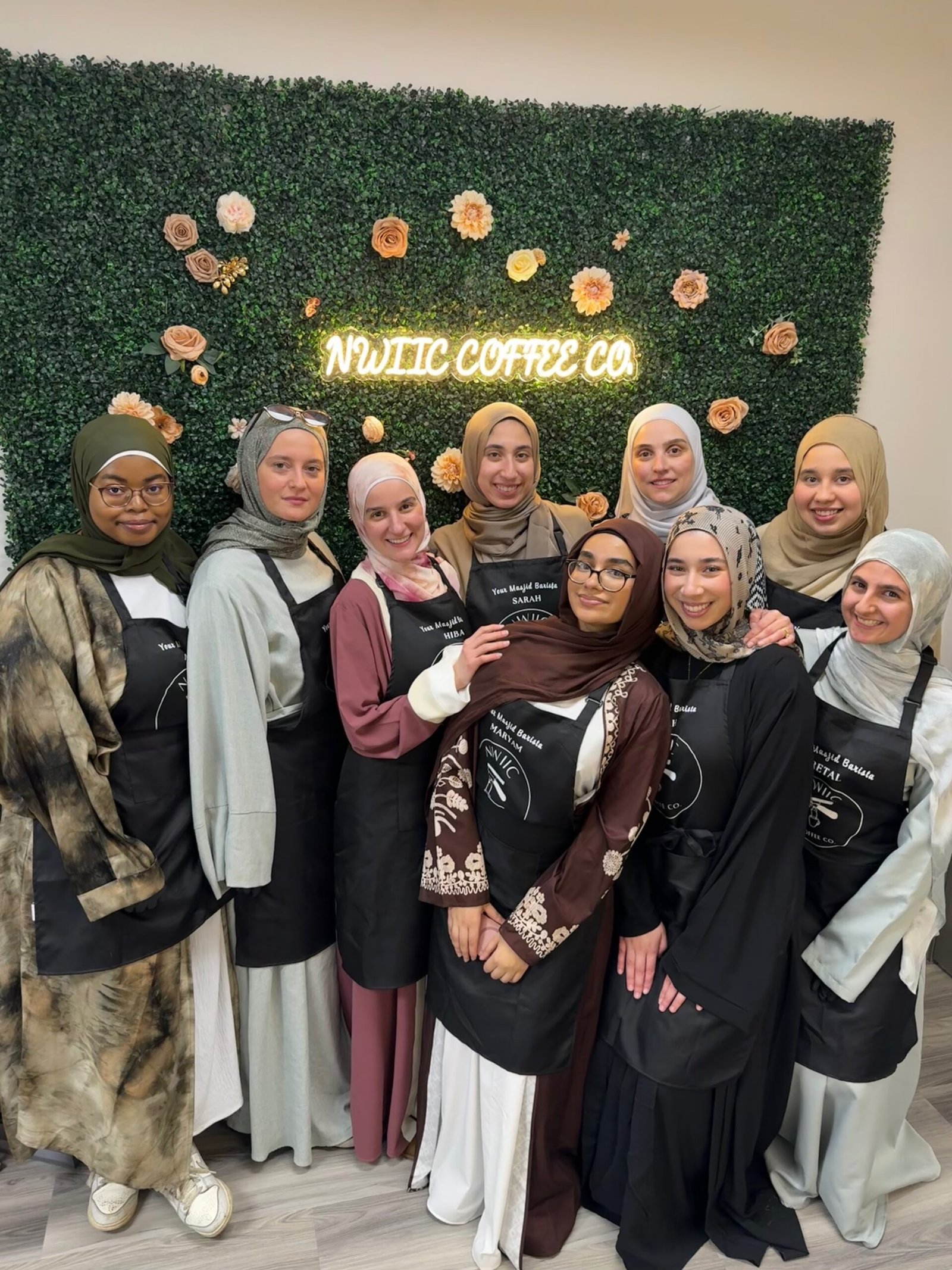 NWIIC Coffee Co. team in front of the shop sign